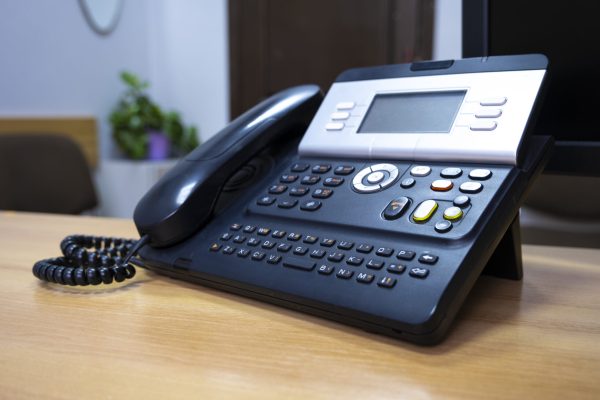Phone device on office table, communication technology concept.